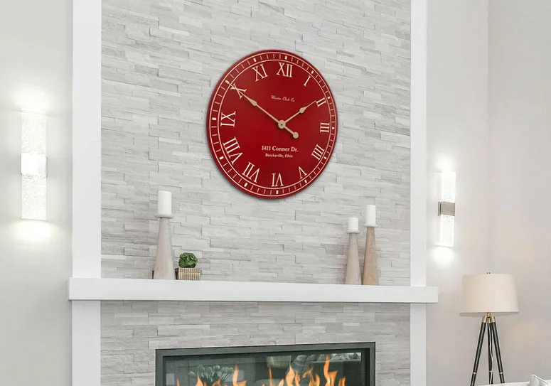 red and white wall clock above brick fireplace